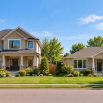 Large two-storey Ontario-style house beside a smaller single-storey bungalow, illustrating downsizing and home equity
